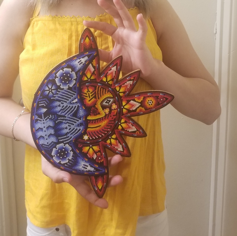 This is a wooden sun and moon
